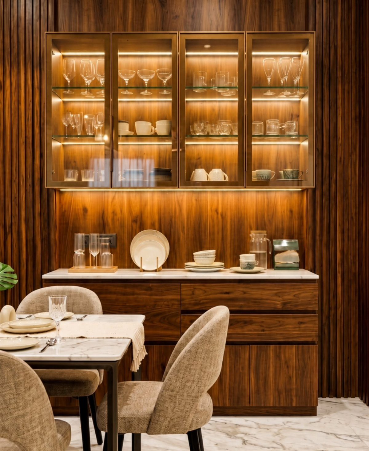 23 Modern Luxury Dining Room Ideas with Photos 10 Dining area with warm wood paneling, illuminated glass cabinets, and beige upholstered chairs.