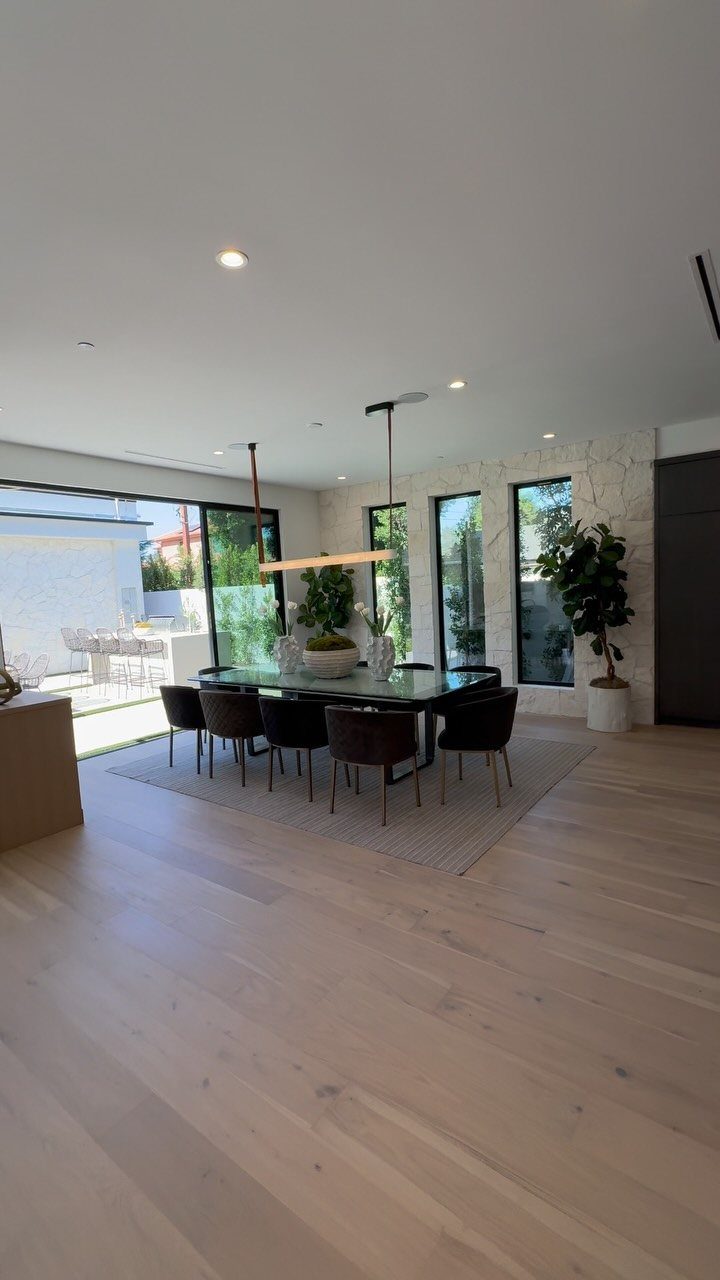 Modern dining area with oval table and chairs in a bright open layout.