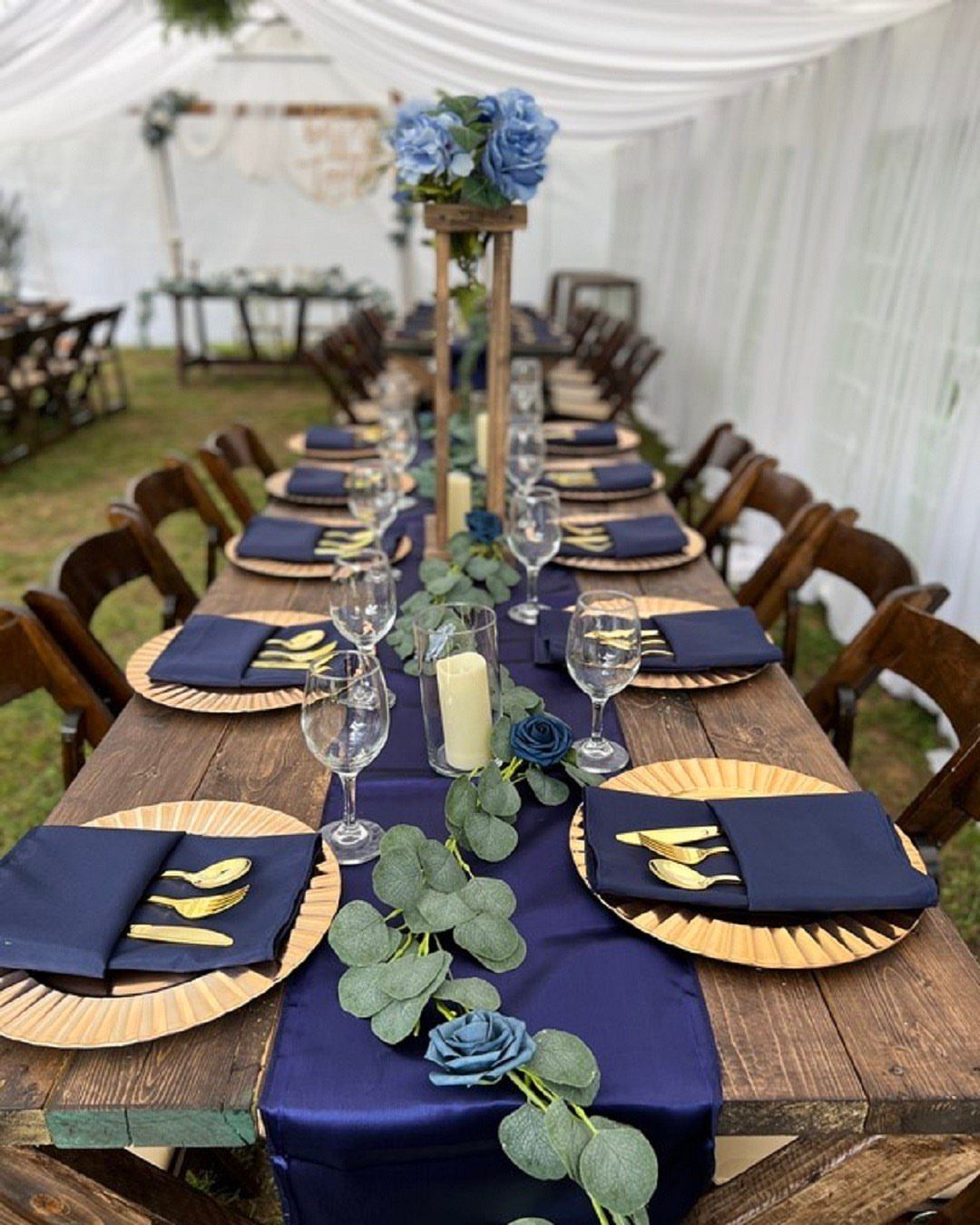7 Navy Blue Fall Decor Ideas for a Cozy Seasonal Home 1 Navy blue table runner with eucalyptus and blue roses on a wooden table.