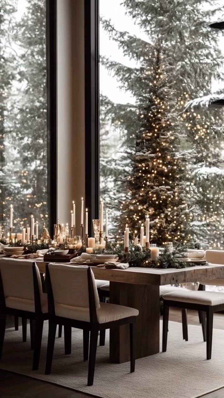 10 Neutral Color Christmas Decor Ideas for a Cozy Home 3 Rustic dining table with white candles and greenery overlooking a snowy Christmas tree.