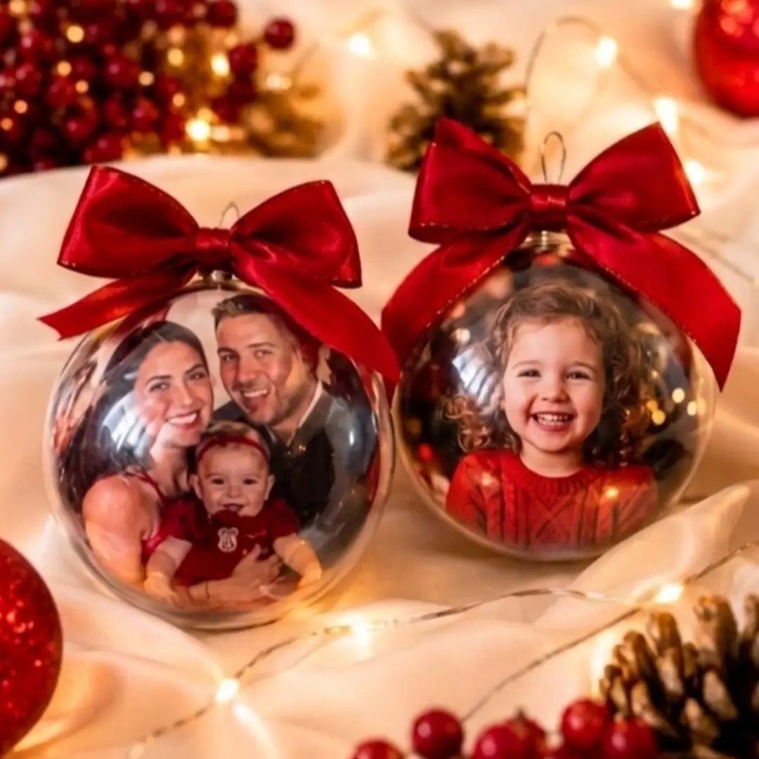 29 New Ideas for Christmas Decorating to Try in 2026 21 Clear glass Christmas ornaments with family photos inside and red satin bows.