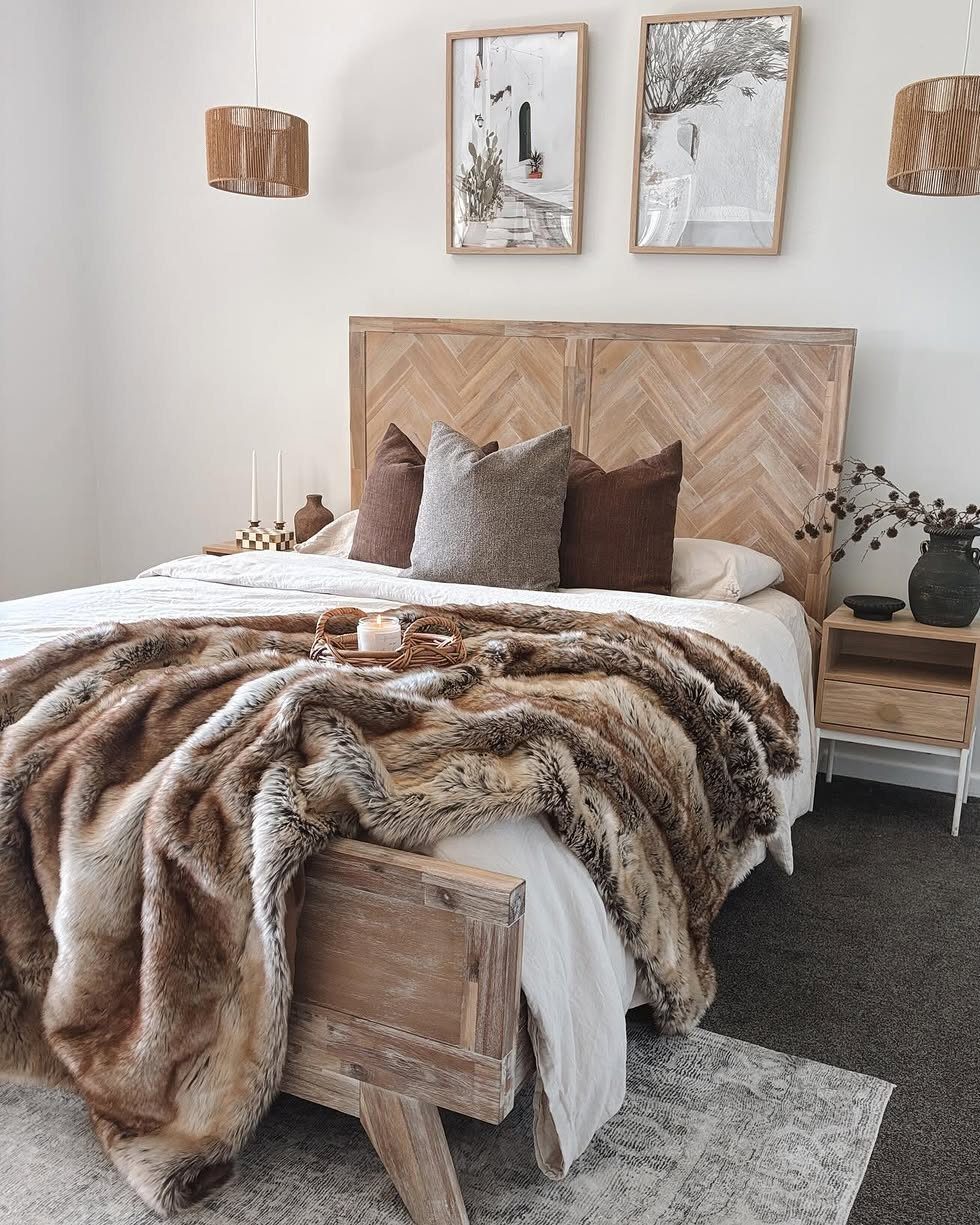 29 New Ideas for Christmas Decorating to Try in 2026 22 Brown faux fur throw blanket draped over a white bed in a cozy bedroom