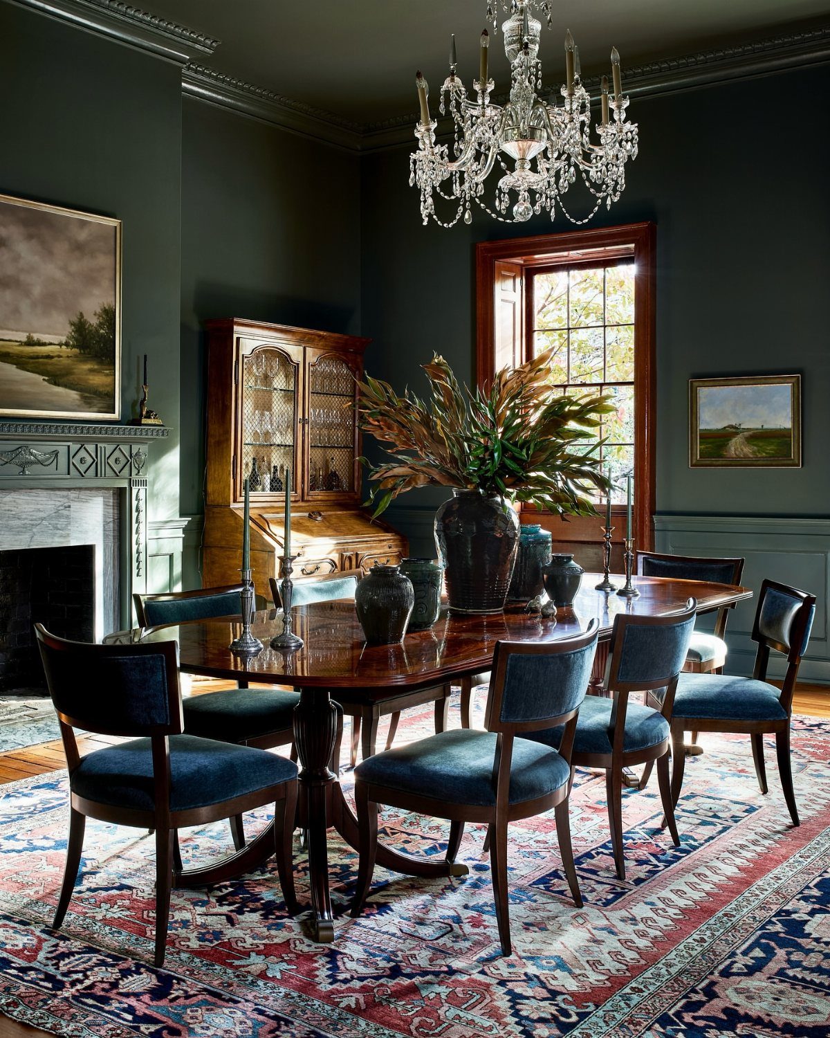 9 Old Money Dining Room Ideas for Timeless Elegance 8 Formal dining room featuring hunter green walls and navy blue upholstered chairs around a mahogany table.