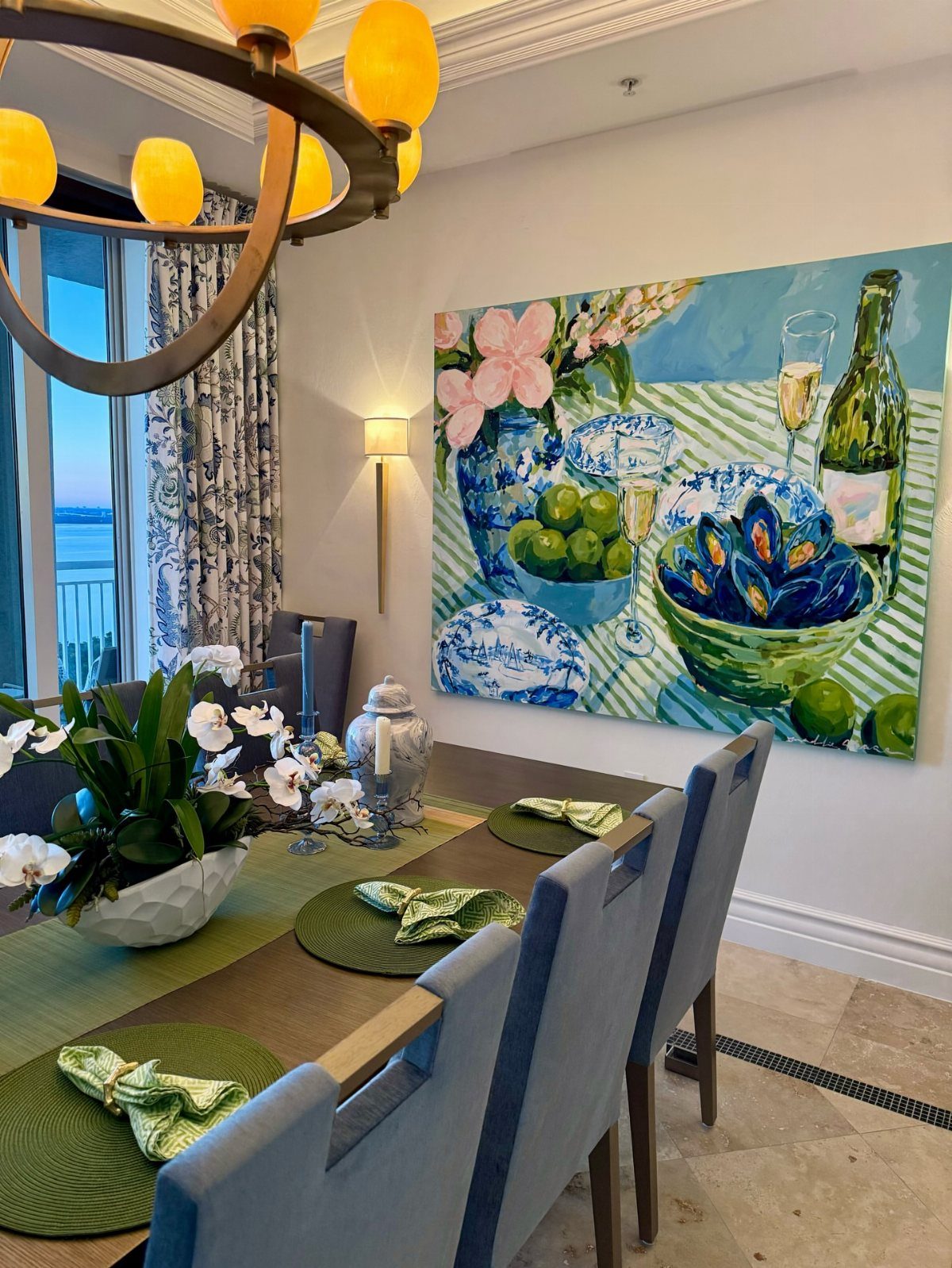 9 Old Money Dining Room Ideas for Timeless Elegance 2 Large colorful still life painting hanging above a dining table with blue chairs.