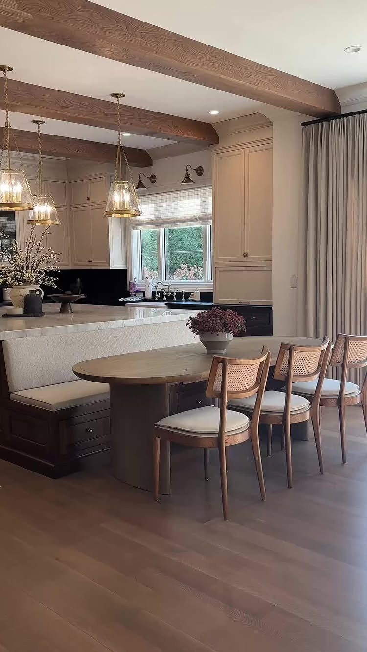 13 Open Concept Dining Room Ideas with Photos 4 Oval wooden dining table and bench next to a white marble kitchen island