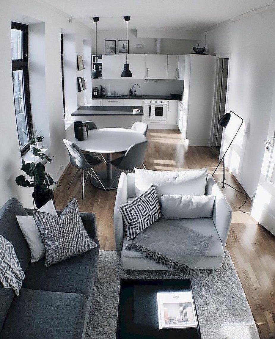 13 Open Concept Dining Room Ideas with Photos 2 Open concept living space with grey furniture, round dining table, and white kitchen.