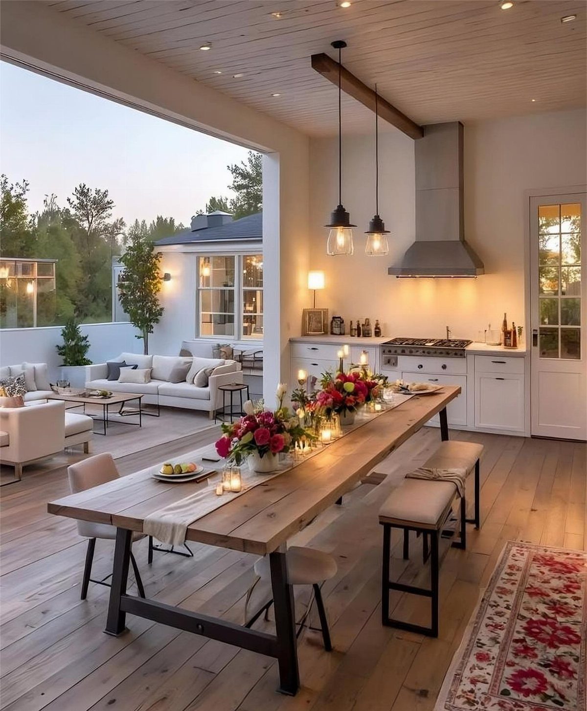 13 Open Concept Dining Room Ideas with Photos 8 Long wooden dining table in an open concept room connecting kitchen and patio.