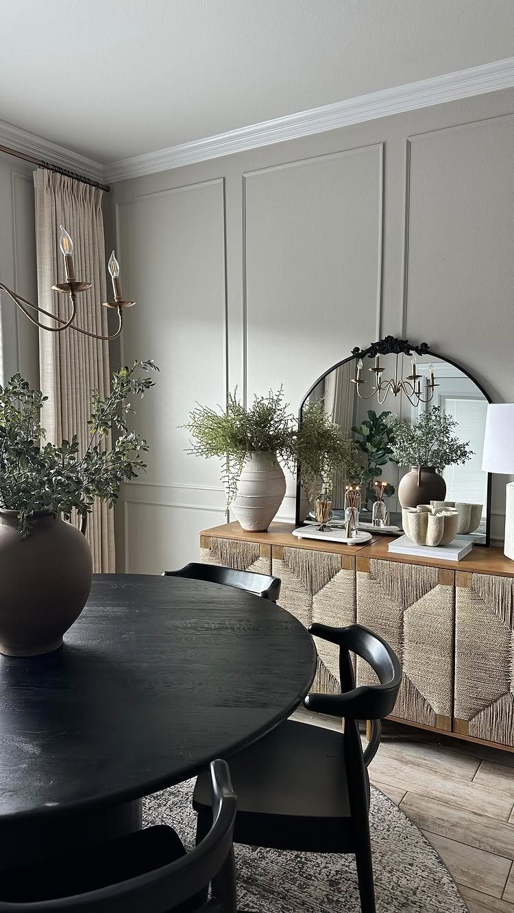 Wooden sideboard with geometric patterns against a grey paneled wall in a dining room
