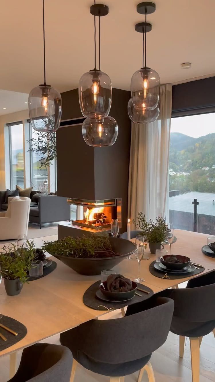 8 Ideas for an Open Living Room Dining Room Layout 8 Modern open living and dining area with a double-sided fireplace and glass pendant lights.