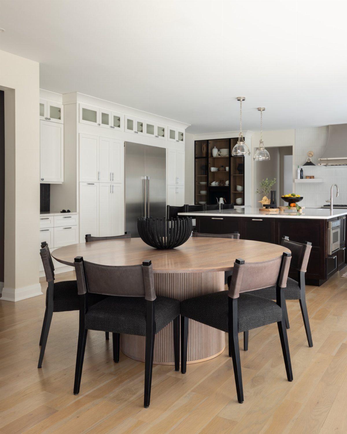 8 Ideas for an Open Living Room Dining Room Layout 5 Round wooden dining table with grey chairs in a modern open concept kitchen