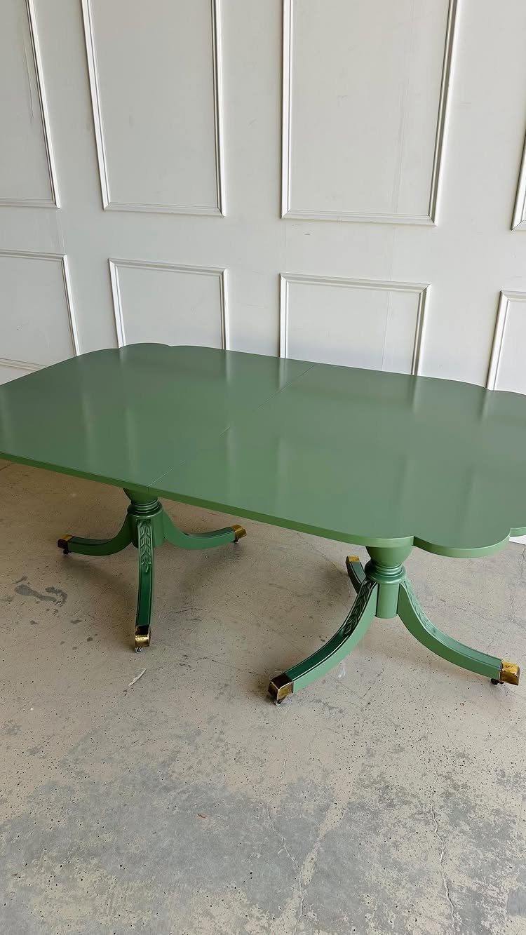 5 Painted Dining Room Table Ideas with Photos 2 Sage green painted dining table with glossy finish against a white paneled wall.