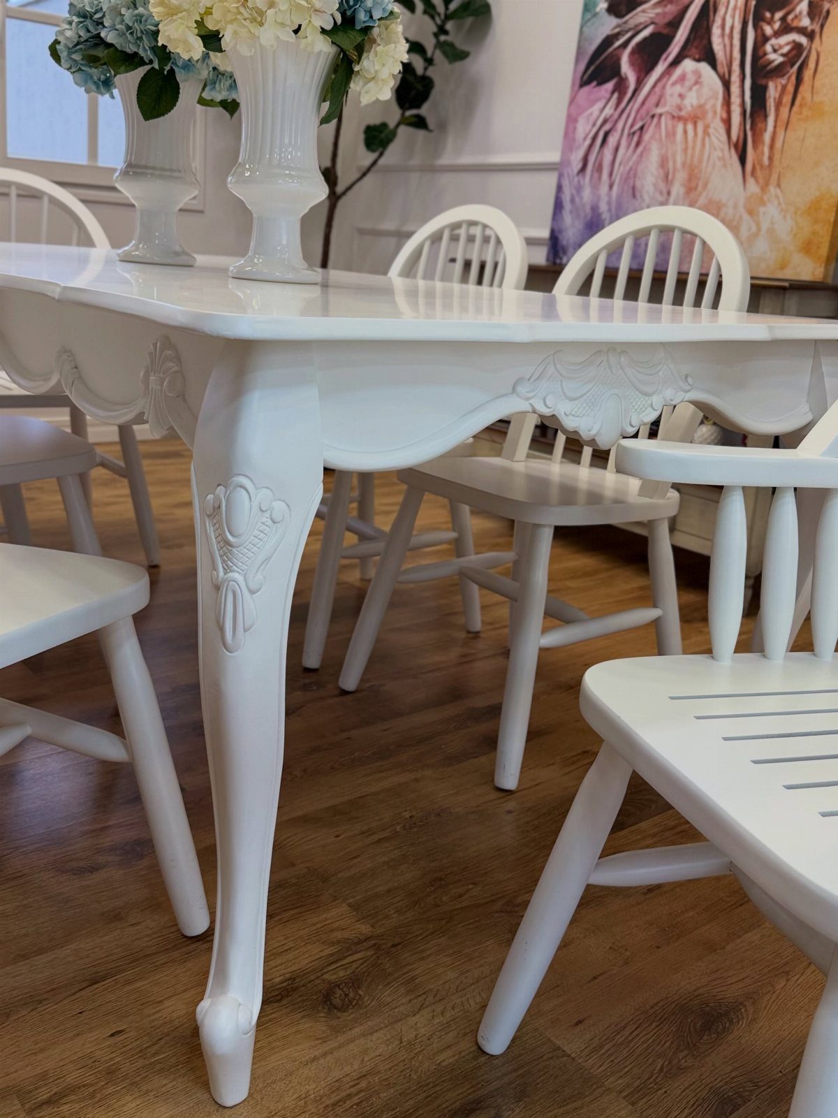 5 Painted Dining Room Table Ideas with Photos 1 White painted wooden dining table with ornate carvings and matching white chairs.