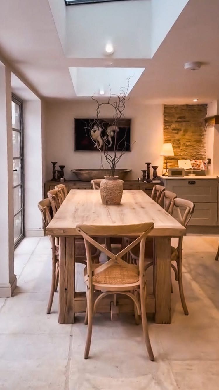 11 Rustic Modern Dining Room Ideas with Real Character 6 Light wooden dining table with cross-back chairs in a bright, rustic modern room.