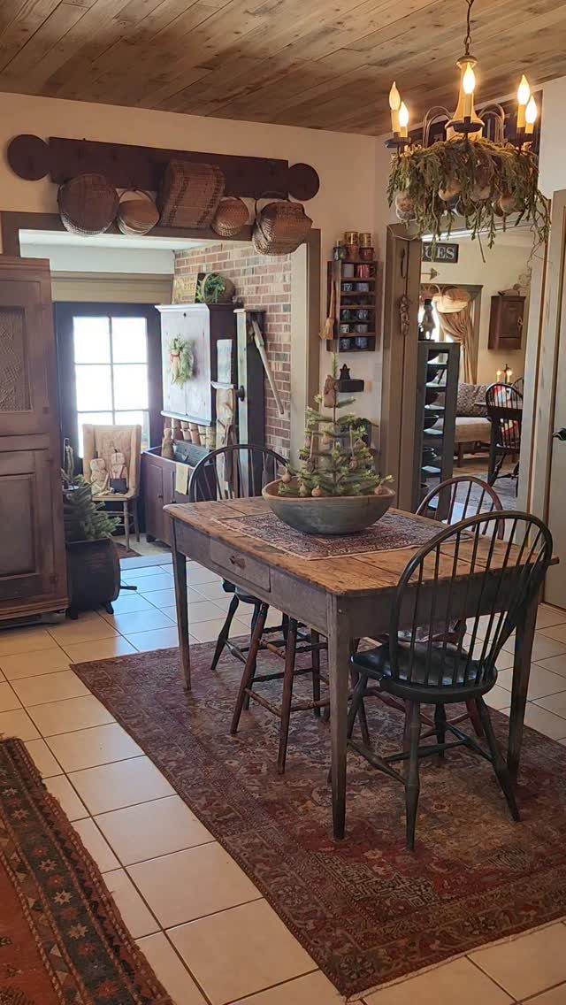 11 Rustic Modern Dining Room Ideas with Real Character 8 Rustic wooden dining table with black chairs on a red rug under wood ceiling