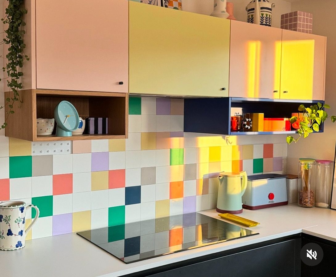 15 Small Breakfast Room Ideas for Cozy Spaces 14 Colorful square tiled backsplash in a kitchen with pastel cabinets and white countertops.