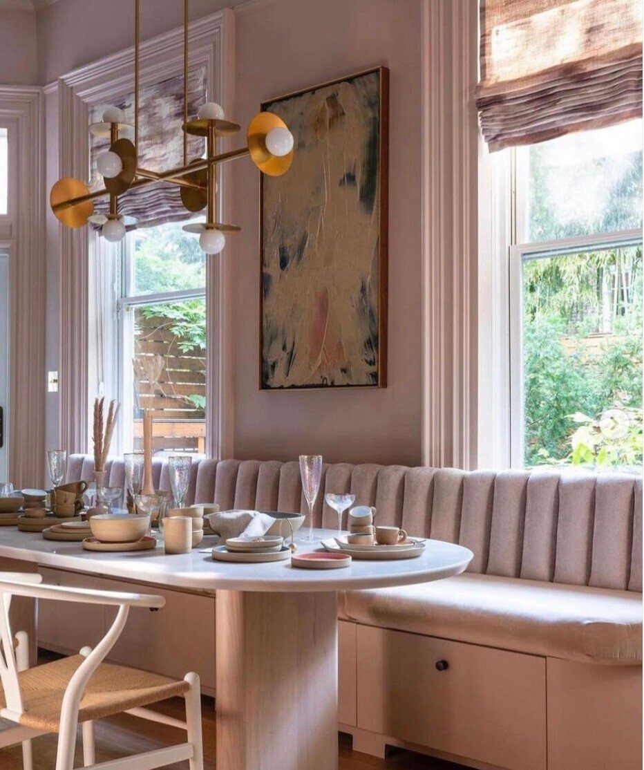 15 Small Breakfast Room Ideas for Cozy Spaces 5 Sleek breakfast nook with a round table, fluted banquette seating, and gold lighting.