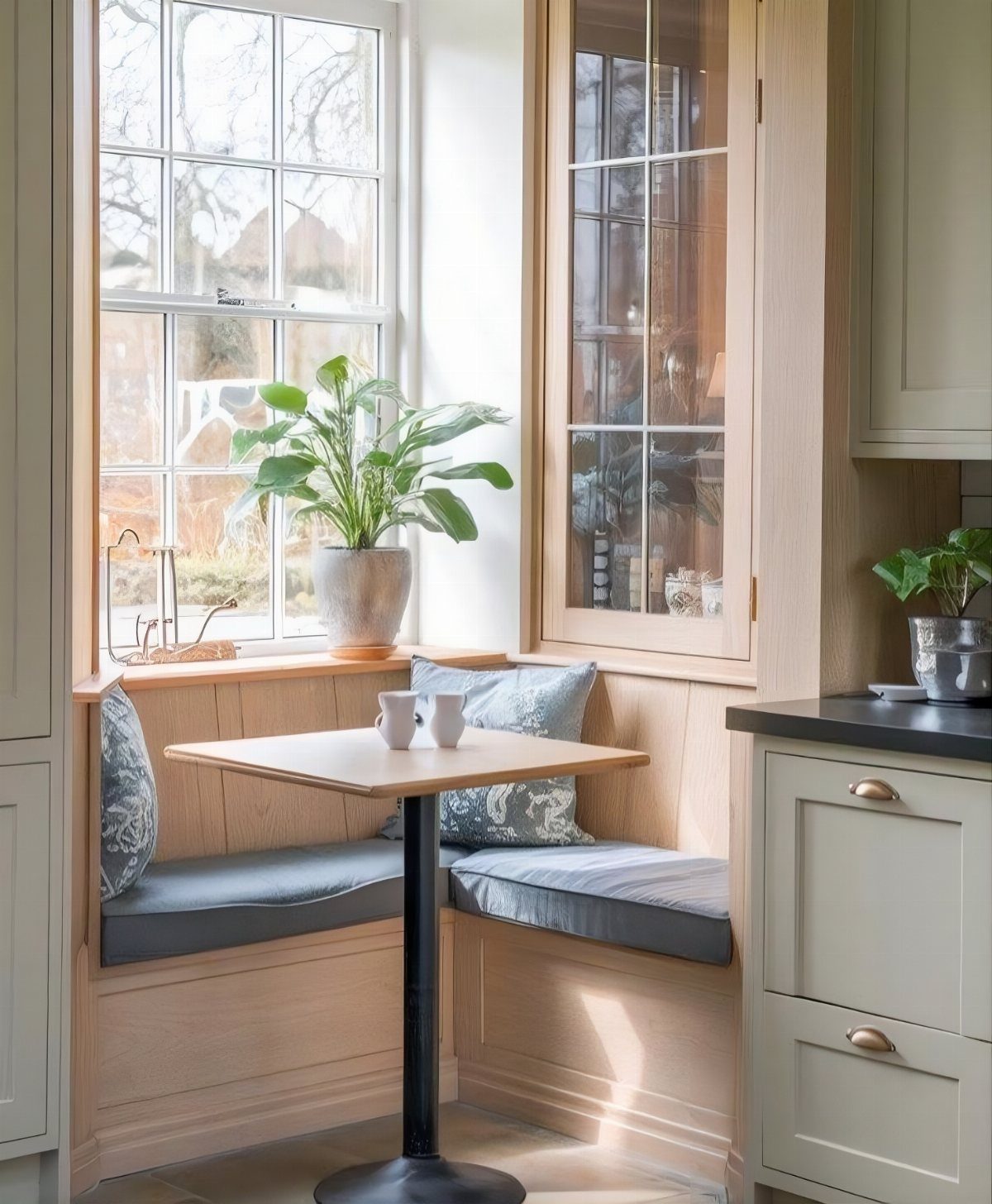 12 Small Dining Area Design Ideas That Maximize Space 2 L-shaped built-in wooden dining bench with grey cushions and a small square table.
