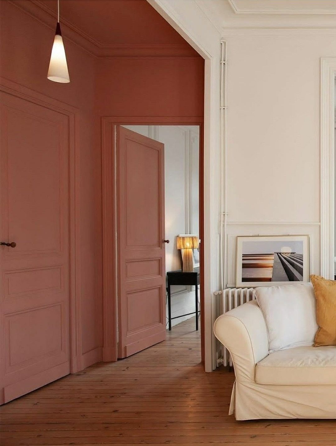 15 Small Living and Dining Room Ideas That Maximize Space 8 Terracotta painted walls and ceiling contrasting with a white living room area.