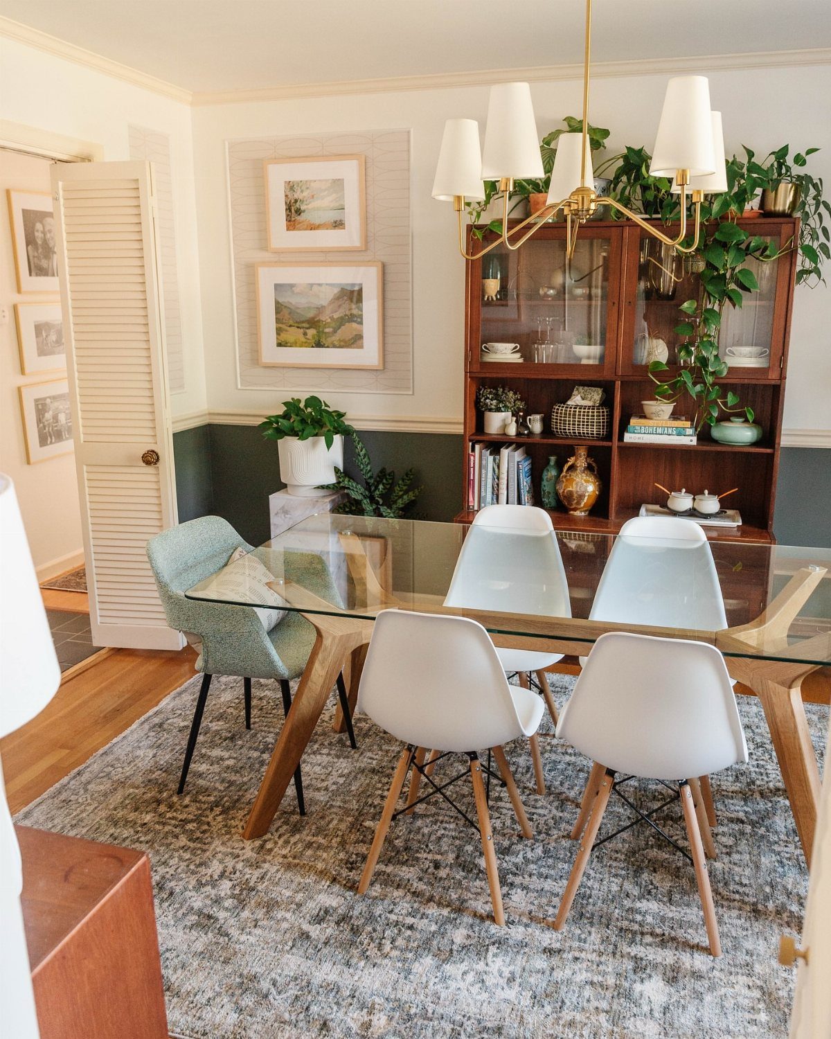 15 Small Living and Dining Room Ideas That Maximize Space 3 Glass-top dining table with white chairs and a wooden hutch in a bright room.