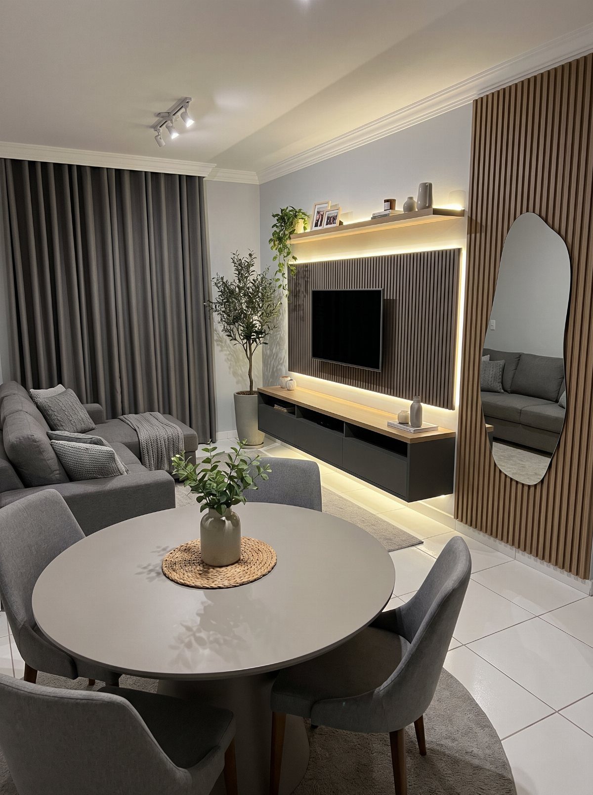 15 Small Living and Dining Room Ideas That Maximize Space 15 Small living and dining room with grey furniture and wood-slat wall paneling.