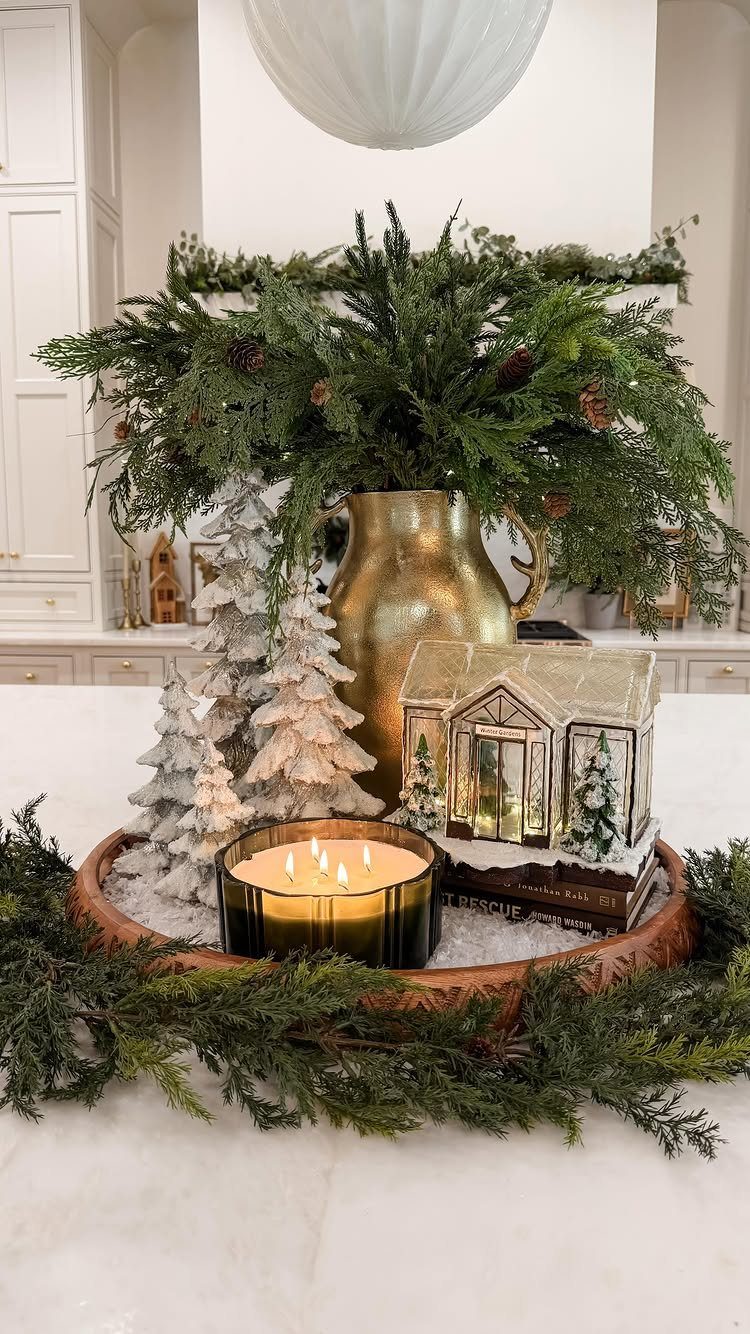 7 Table Centerpiece Ideas for Christmas That Feel Fresh 1 Snowy white decorative trees and evergreen branches in a festive Christmas table centerpiece.