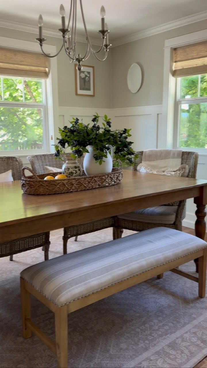 Traditional Modern Dining Room Ideas: 20 Ways to Blend Styles 18 Wooden dining table with a striped bench and wicker chairs in a bright room.