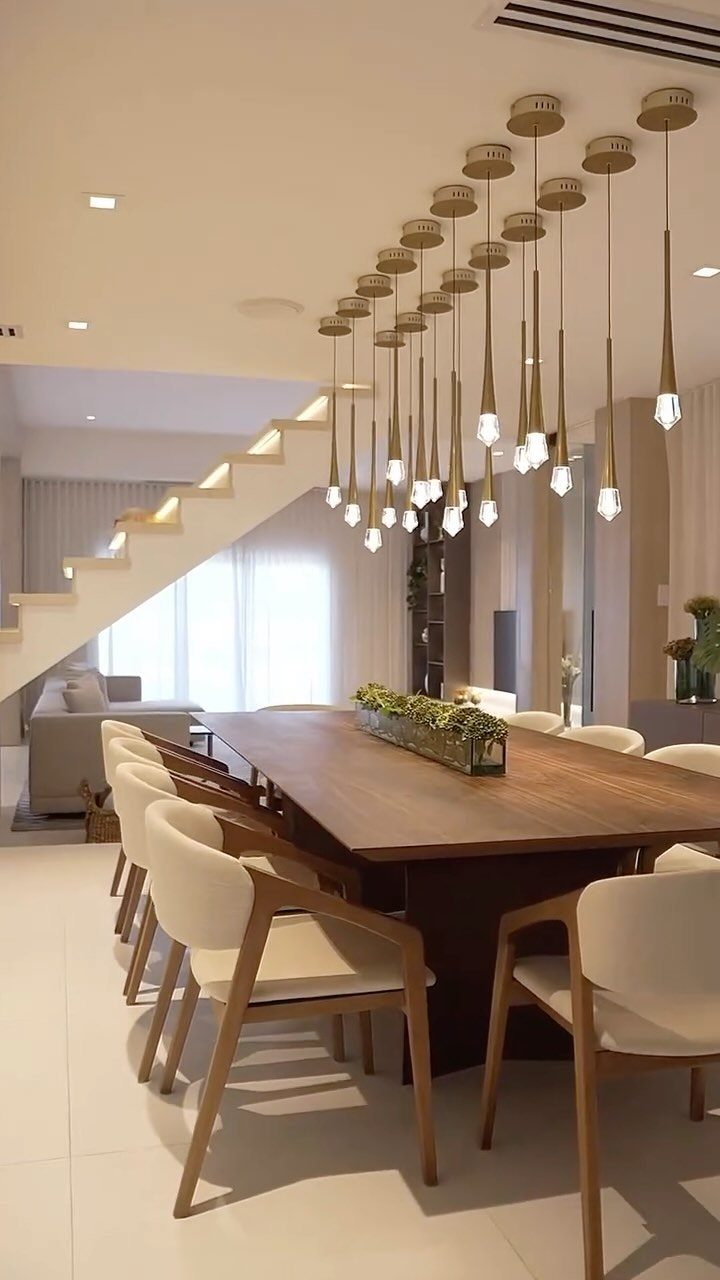 Traditional Modern Dining Room Ideas: 20 Ways to Blend Styles 9 Wooden dining table with cream chairs under a gold multi-pendant metal chandelier.