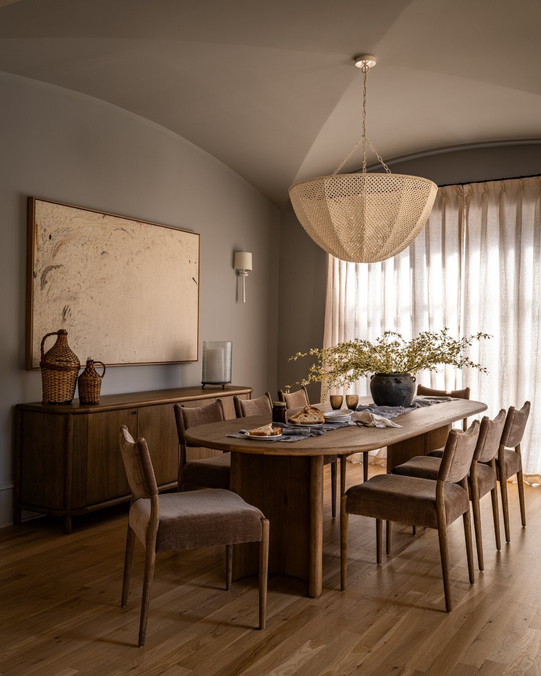 Traditional Modern Dining Room Ideas: 20 Ways to Blend Styles 12 Dining room with neutral grey walls, wooden table, and grey upholstered chairs.