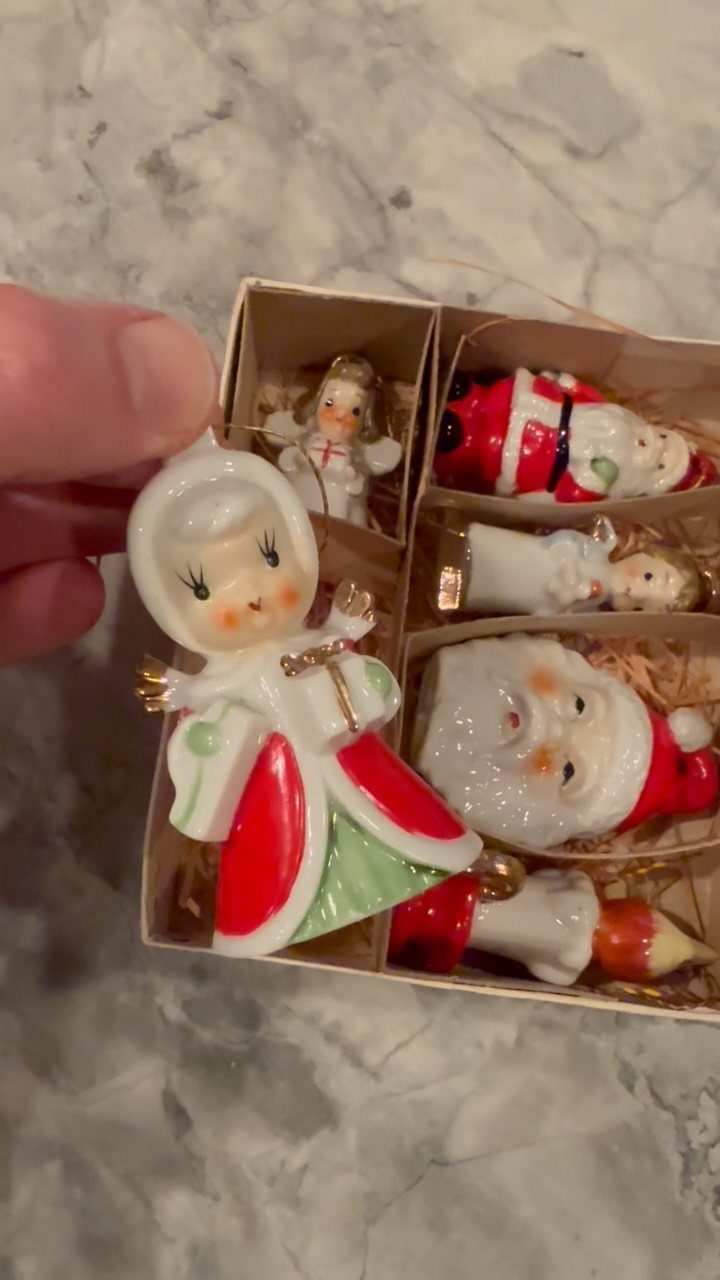 Vintage ceramic Christmas ornaments including Santa and an angel in a divided box.