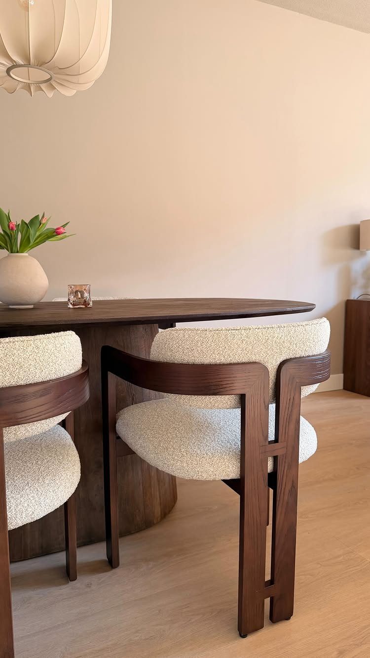 9 Wabi Sabi Dining Table Ideas for an Organic, Lived-In Space 6 Dark wood dining table with organic edges and cream bouclé chairs in minimalist room
