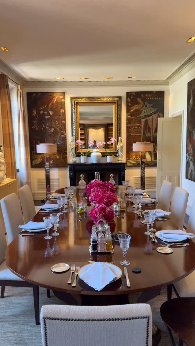 Traditional dining room with large wall art and a gold-framed mirror above the fireplace.